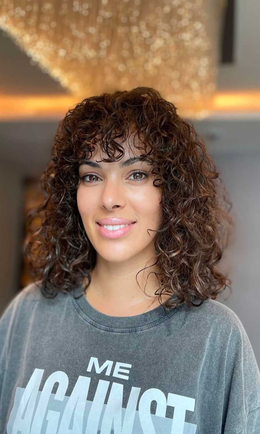 Defined brunette curls with a shaped fringe
